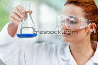 Science student looking at a liquid