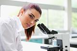 Brunette posing with a microscope