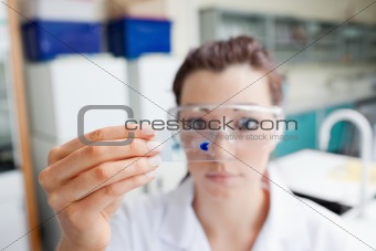 Science student looking at a microscope slide