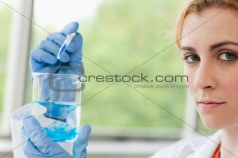 Scientist dropping liquid in a beaker