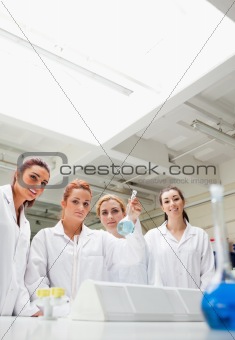 Portrait of chemistry students holding a flask