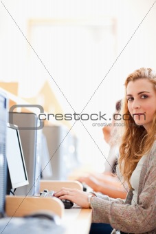 Portrait of a student posing with a computer