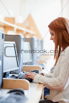 Portrait of a young student working with a computer