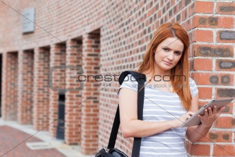 Serious student holding a tablet computer