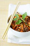 Asian style salad with carrots, meat and chili peppers