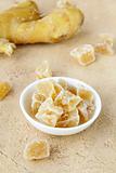 candied ginger and fresh ginger on a beige background
