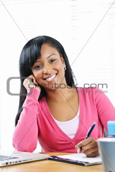 Happy female student studying