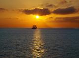 Sailing at sea sunset .