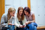 Student showing a text message to her friends
