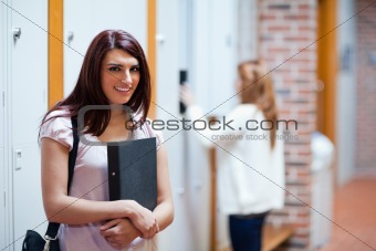 Student standing up with her binder