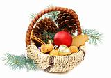 Christmas basket with candies, cookies and spruce branches.
