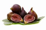 Figs with a green leaf on white background.