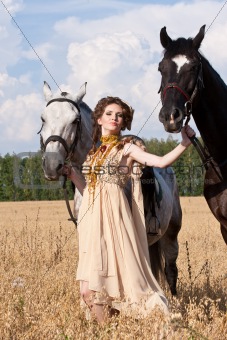 The woman hold two horses