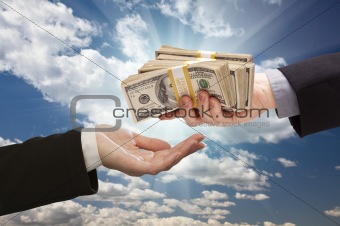 Handing Over Cash with Dramatic Clouds and Sky Background.