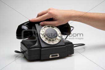 Vintage telephone being picked up
