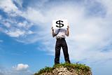 Businessman standing on a peak and holding money mark