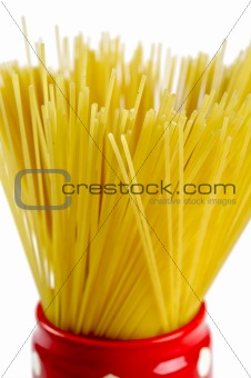Spaghetti inside a red jar closeup