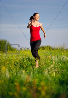 Woman running on a sunset field