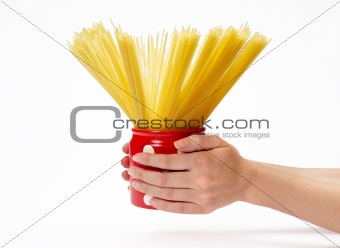 Woman's hands holding red jar with spaghetti inside