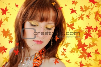 Beautiful autumn fairy woman with golden make-up. falling leaves