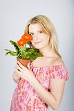 Pretty woman with orange house plant flower