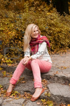 Pretty autumn girl  in yellow park outdoors