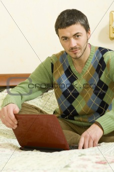 Picture of young handsome man working online from his house