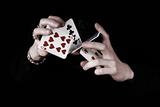 Young magicians hands holding a lot of play cards