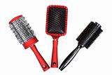 Three red massages comb on white background