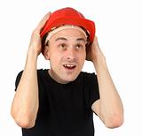 Surprised young man in a red building helmet