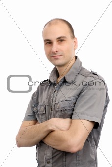 Portrait of a handsome young man with his hands folded