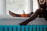 Woman's legs with pumpkin