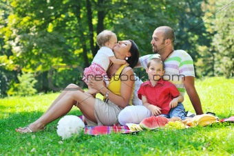 happy young couple with their children have fun at park