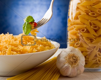 Pasta with tomato sauce on blue background
