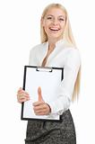 Beautiful woman holds a bulletin board with thumb up
