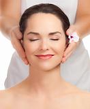 Beautiful young woman getting facial massage