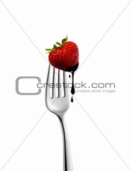 strawberry on  fork with chocolate dripping