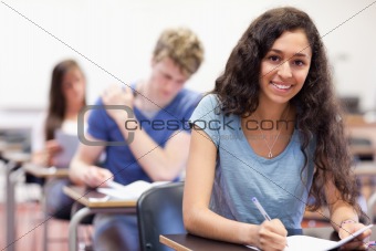 Smiling students working on an assignment