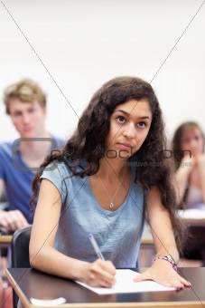 Portrait of a focused student taking notes
