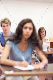 Portrait of serious students taking notes