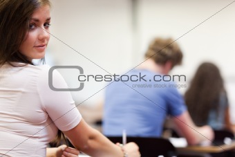 Playful student sitting at a table