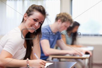 Smiling woman writing