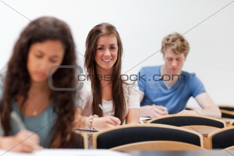 Smiling young students sitting on a chair
