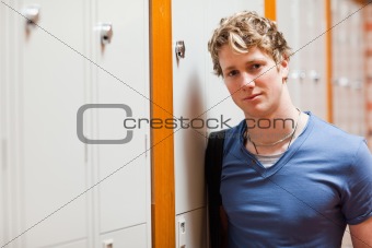 Portrait of a student leaning on a locker