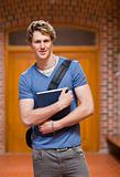 Portrait of a handsome student holding a book
