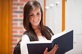 Smiling student holding a book