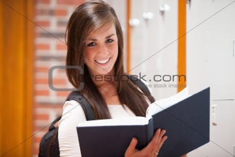Smiling student holding a book