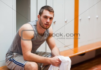 Young sports student sitting on a bench