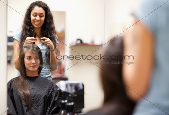 Woman combing the hair of a customer