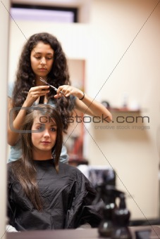 Portrait of a young woman having a haircut